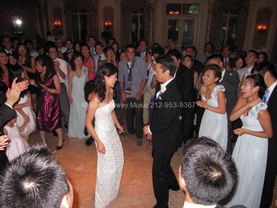 Bride and Groom First Dance with friends and family looking on