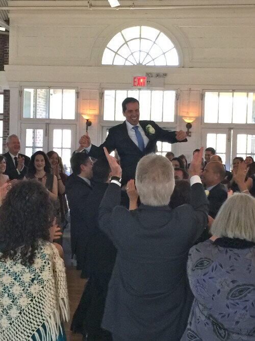 Prospect Park Picnic House Groom smiling while being lifted on Chair