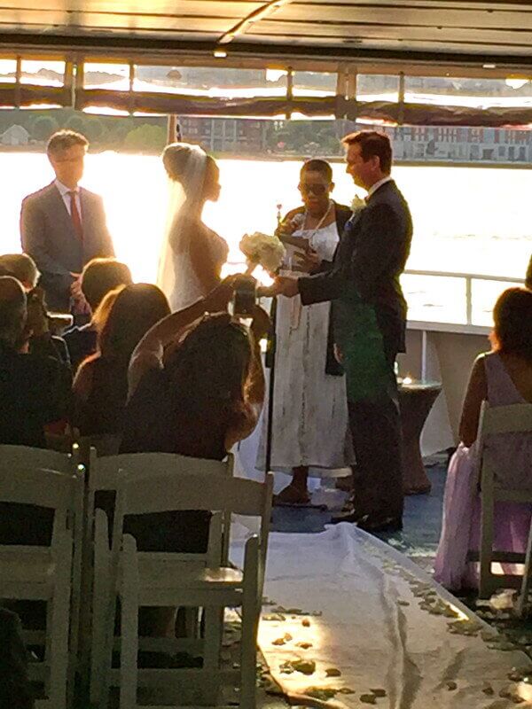 Bride and groom getting married on Yacht