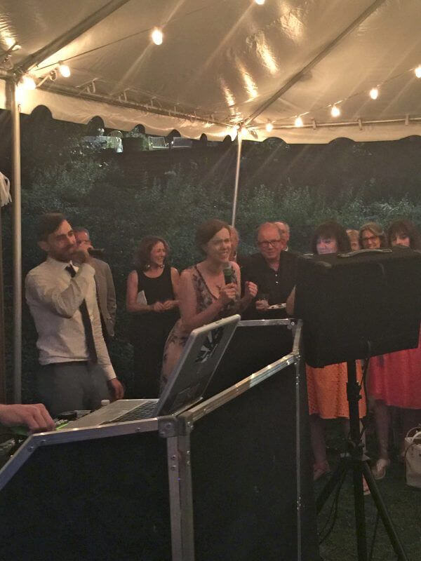 Bride and Groom singing karaoke during their wedding at lakefront in south salem new york