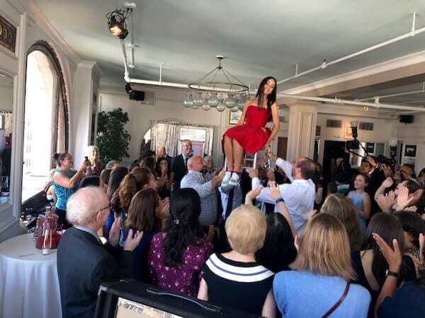 bat mitzvah girl lifted during Hora