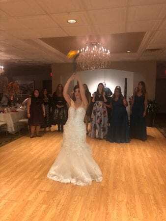 bride about to throw bouquet to dj song at Perona Farms wedding in new Jersey