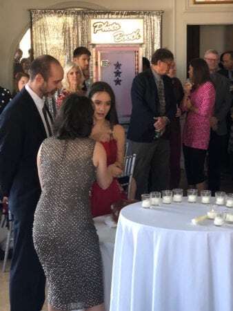 Bat Mitzvah girl and her parents candlelighting