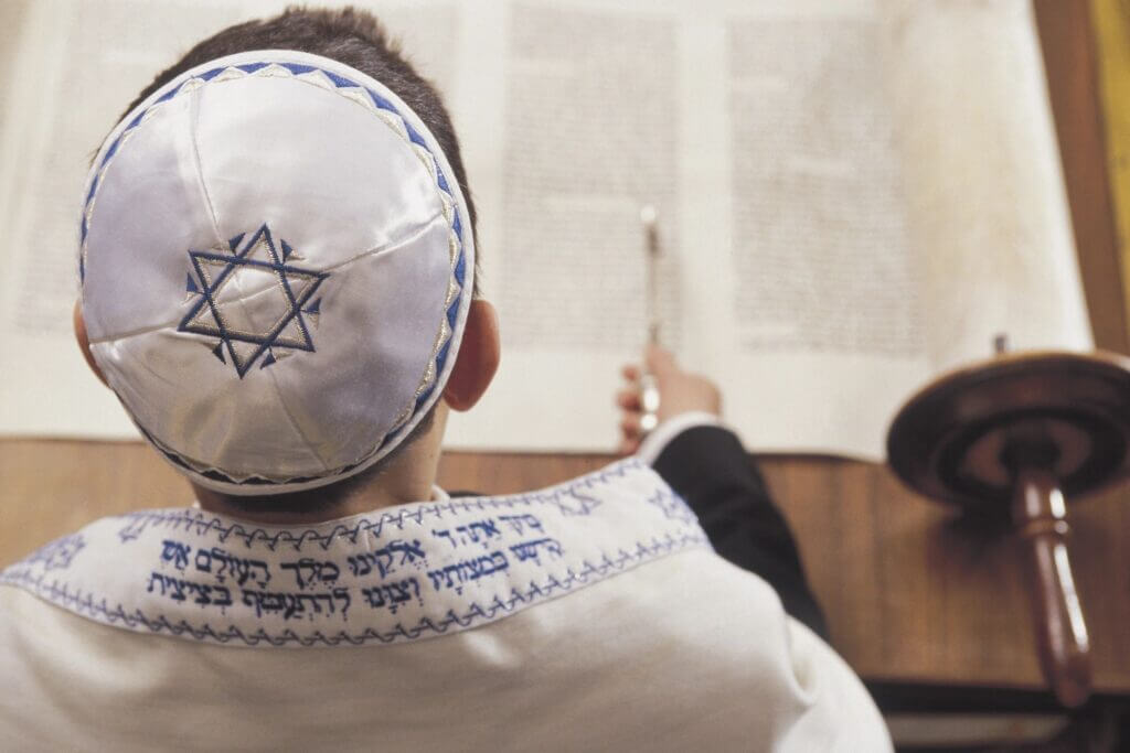 back of bar mitzvah boy at ceremony