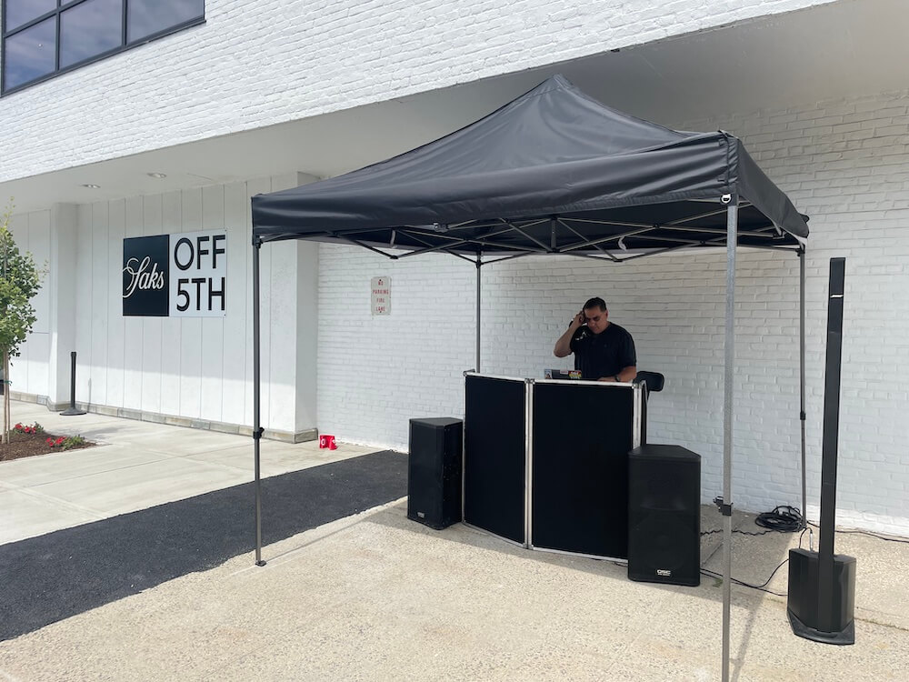 DJ Dave Swirsky under tent at saks off fifth grand opening