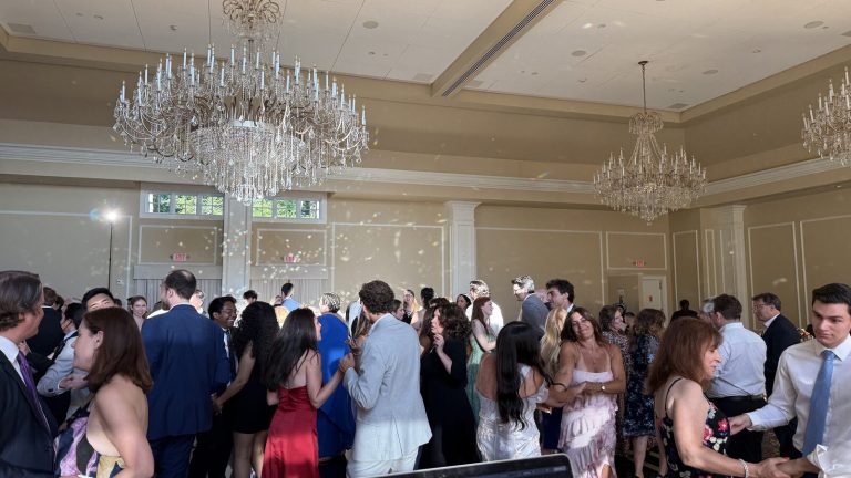 Wedding guests dancing in a grand New York ballroom