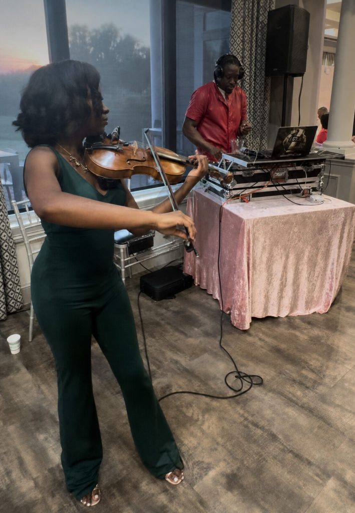 An electric violinist performing live alongside the DJ at a New York wedding