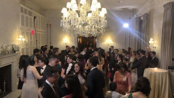 Guests dancing under the chandelier at the Harold Pratt House