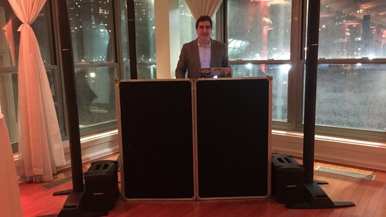 DJ Dave Swirsky set up by the harbor windows at Battery Gardens